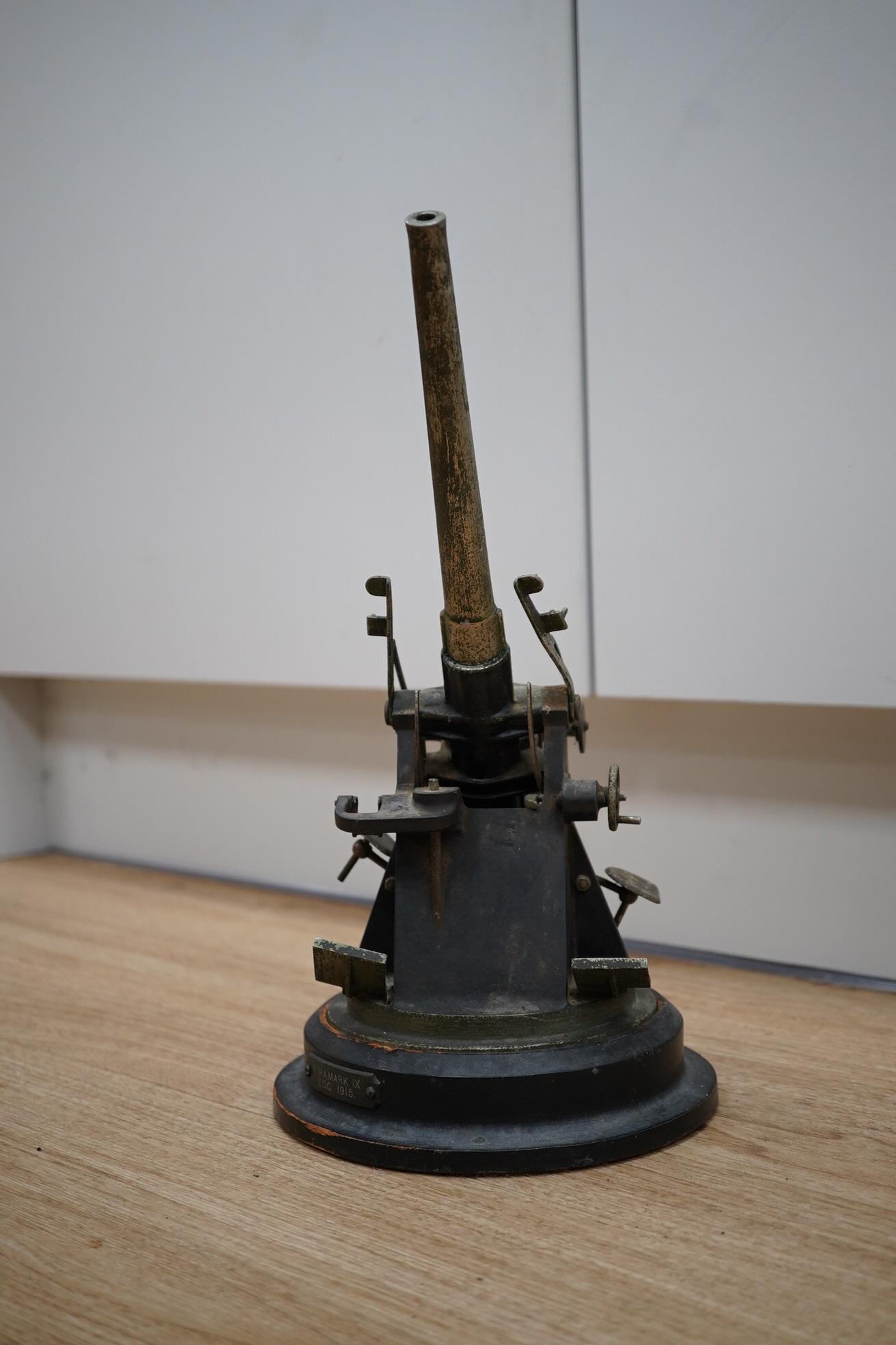 A steel model of a First World War 4 inch mark IX E.O.C. anti-aircraft gun, barrel 18cm, on a turned ebonised pine base with applied label. Condition - fair, some wear overall.